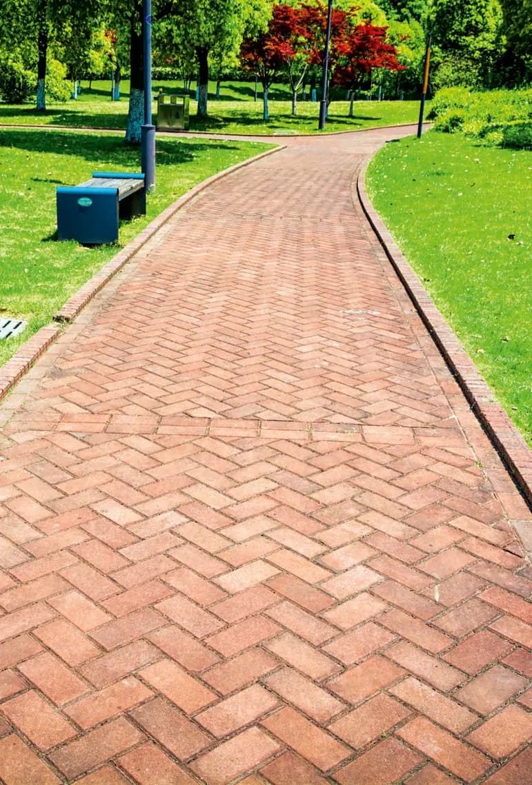 Interlocking paver pathway through a landscaped residential complex