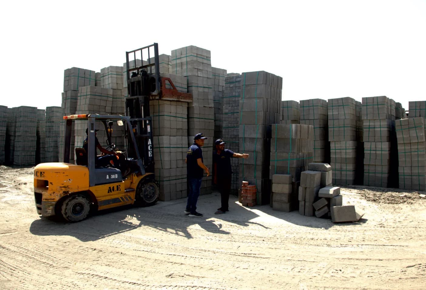 Milestone team loading stacked paver blocks with a forklift at the factory yard