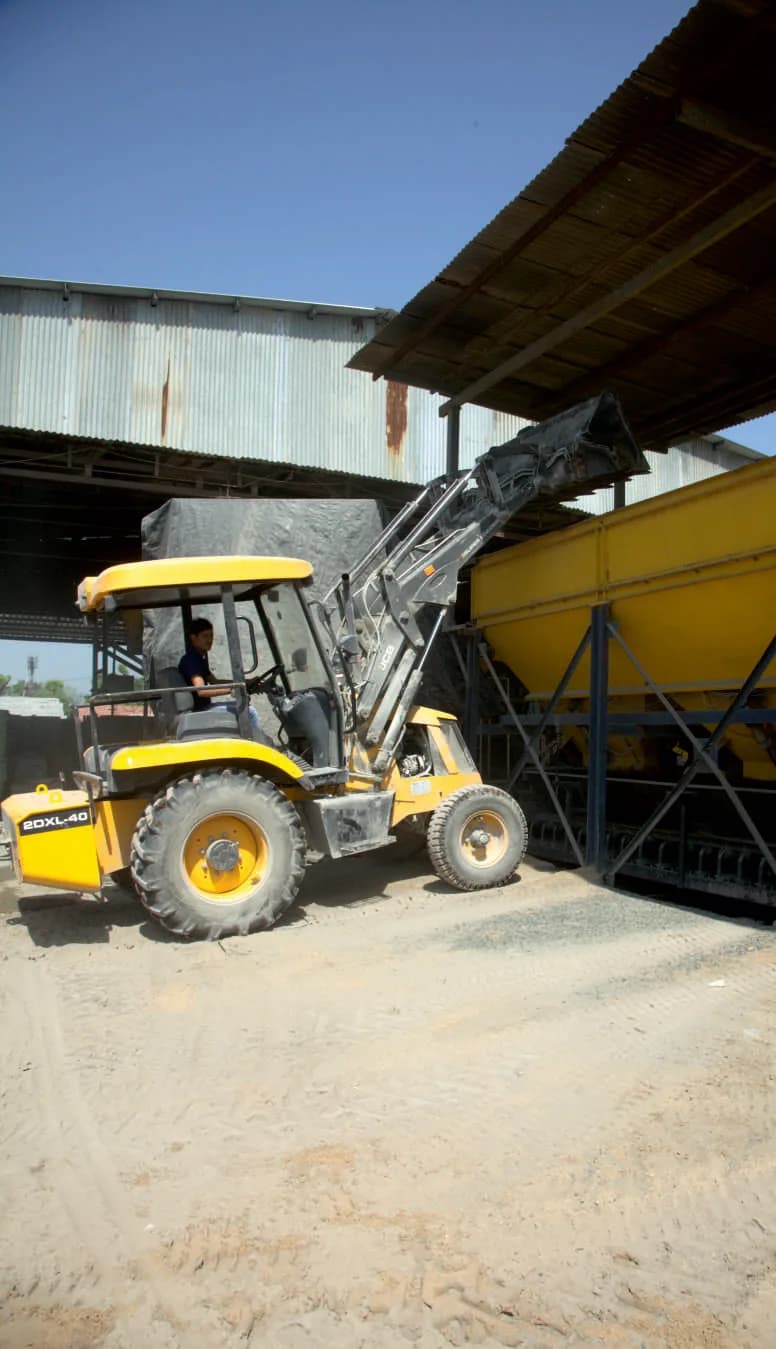 Milestone-branded truck with a Palfinger crane lifting stacked paver blocks for delivery